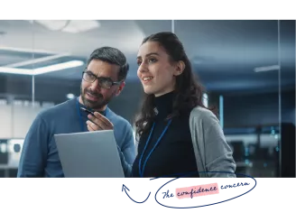 Two engineers with a laptop in a control room