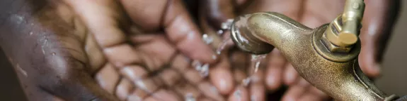 Hands under a tap with running water